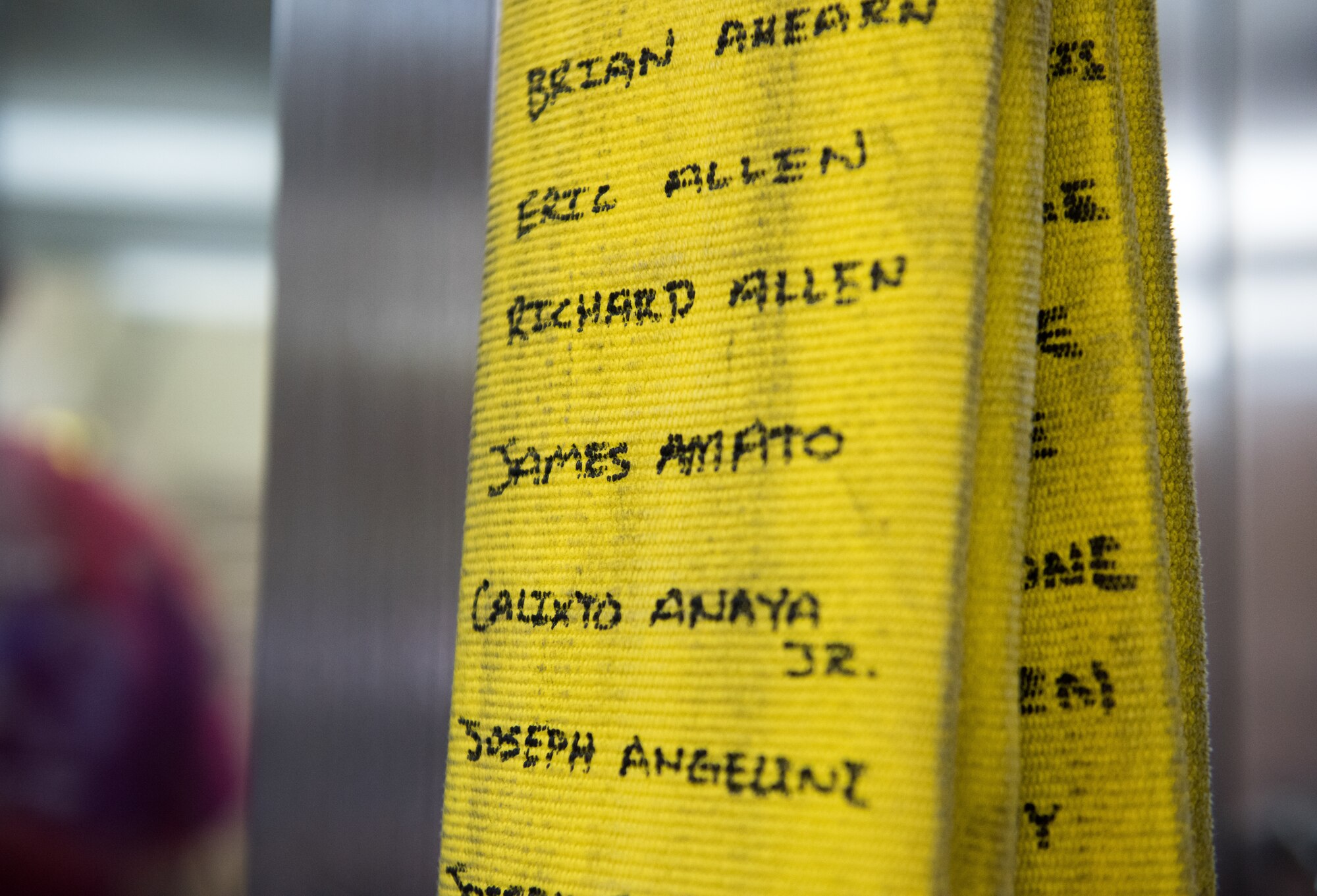 Names of first responders who died during the September 11th attack are displayed on a firehose