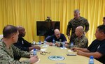 ROTA, Commonwealth of the Northern Mariana Islands – Navy Rear Adm. Brad Cooper, left, Marine Corps Col. Robert “Bams” Brodie, and Lt. Col. Christopher Johnson, standing, discuss defense support of civil authorities with the Hon. Ralph Torres, governor of the Commonwealth of Northern Mariana Islands Islands and representatives from the Federal Emergency Management Agency during a meeting at the local government office, Sept. 11, 2018.  Cooper is the Combined Task Force 76 commander, Brodie is the 31st Marine Expeditionary Unit commanding officer, and Johnson is the Combat Logistics Battalion 31 commanding officer.