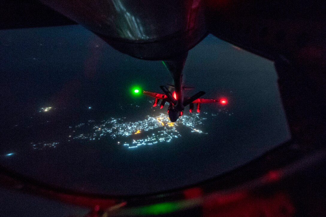 A KC-135 Stratotanker aircraft refuels an EA-6B Prowler aircraft mid-flight.