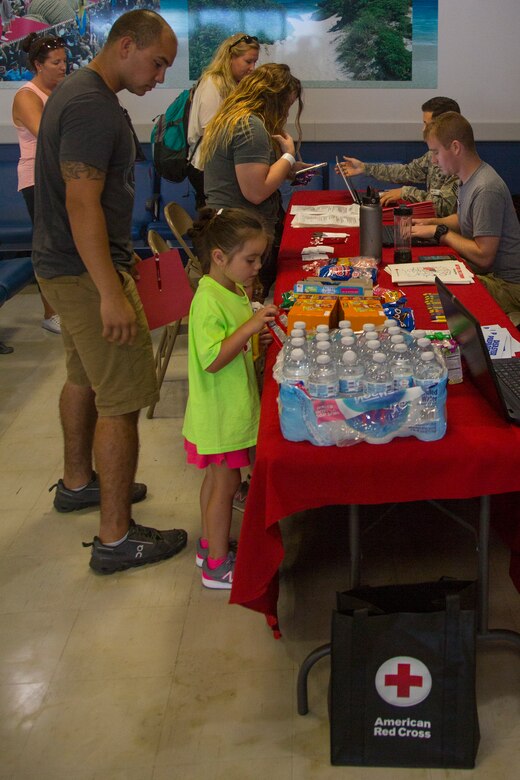 KADENA AIR BASE, OKINAWA, Japan –Volunteers browse the snack and refreshments offered by the American Red Cross during a noncombatant evacuation operations training exercise Aug. 6 at the Samurai Terminal on Kadena Air Base, Okinawa, Japan.