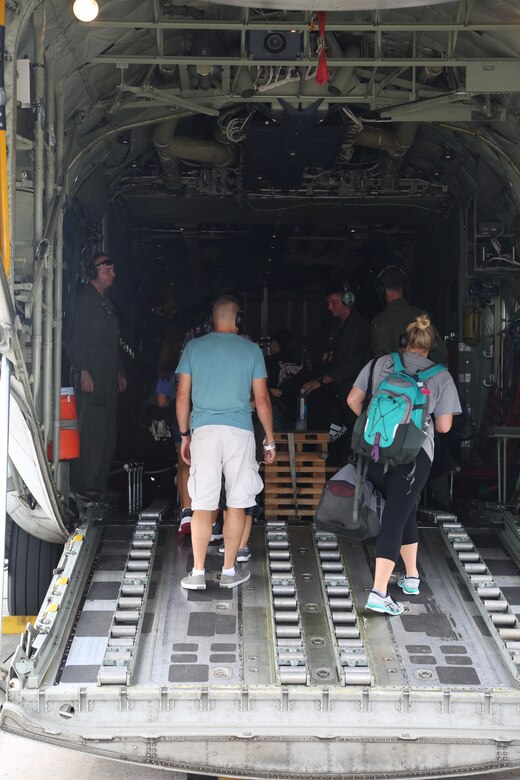 MARINE CORPS AIR STATION FUTENMA, OKINAWA, Japan – Volunteers board a KC-130J Super Hercules during a noncombatant evacuation operations training exercise Aug. 7 at the Marine Corps Air Station Futenma terminal in Okinawa, Japan.
