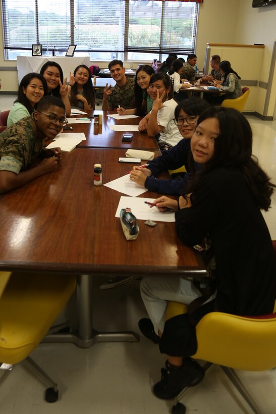 CAMP COURTNEY, OKINAWA, Japan – Students and Marine volunteers pose for a photo during Camp Courtney’s Summer English class Aug. 16 at the Camp Courtney Mess Hall, Okinawa, Japan.