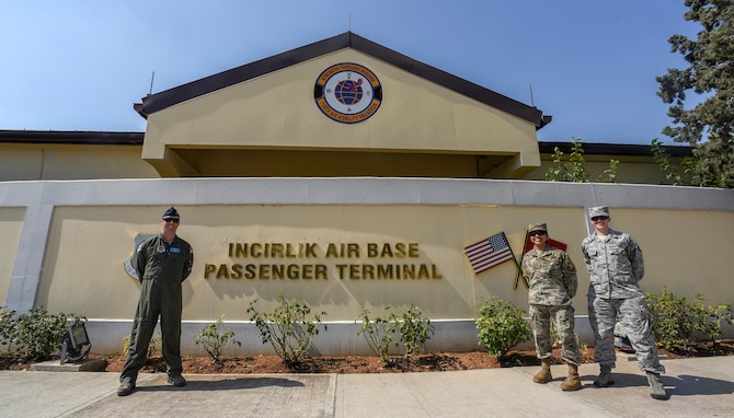U.S. Air Force Airmen pose for a photo in front of the 728th Air Mobility Squadron and PAX terminal building.