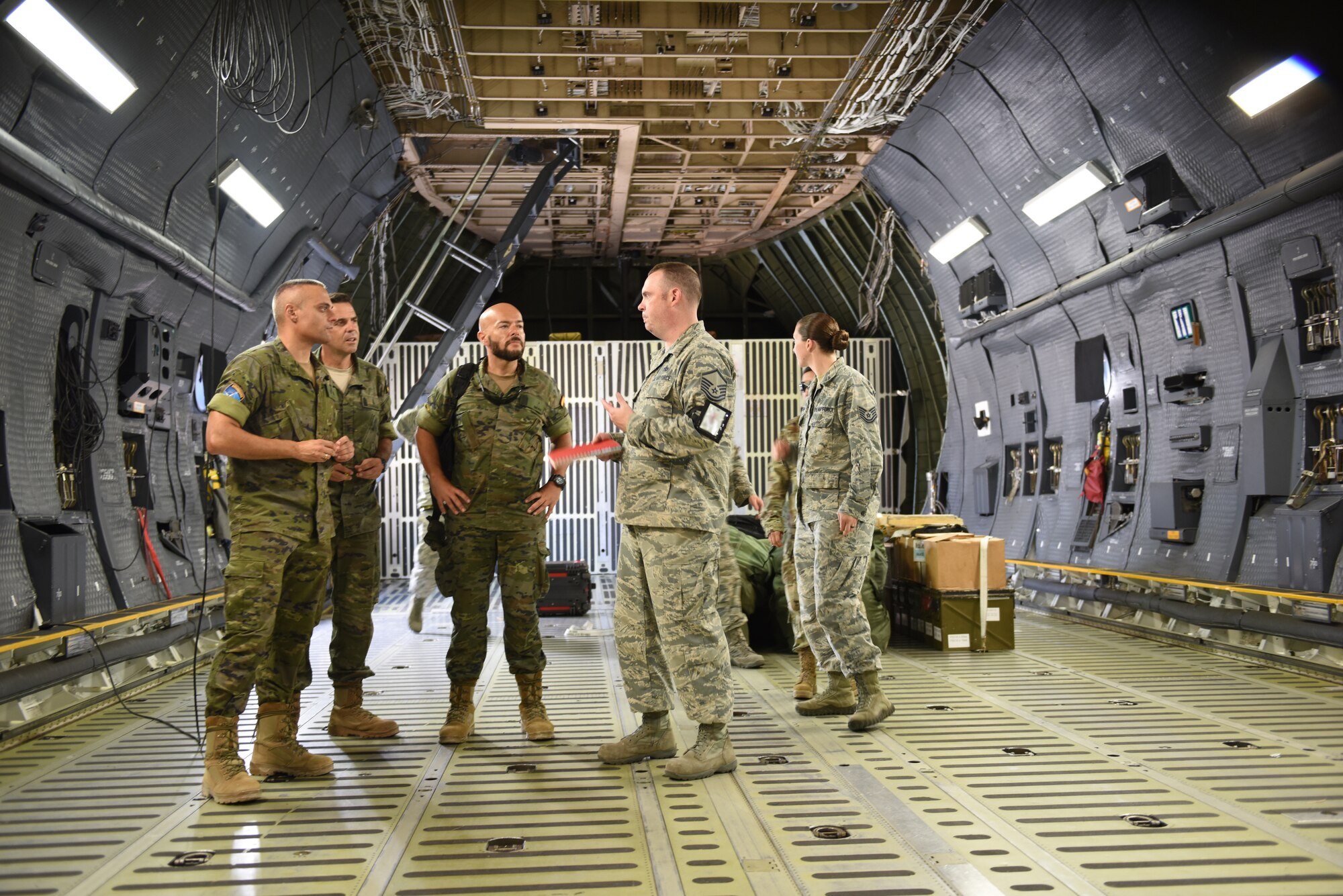 U.S. Air Force Master Sgt. Gene Harper gives members of the Spanish Army a tour of a U.S. Air Force C-5M Super Galaxy, at Incirlik Air Base, Turkey, Sept. 7, 2018