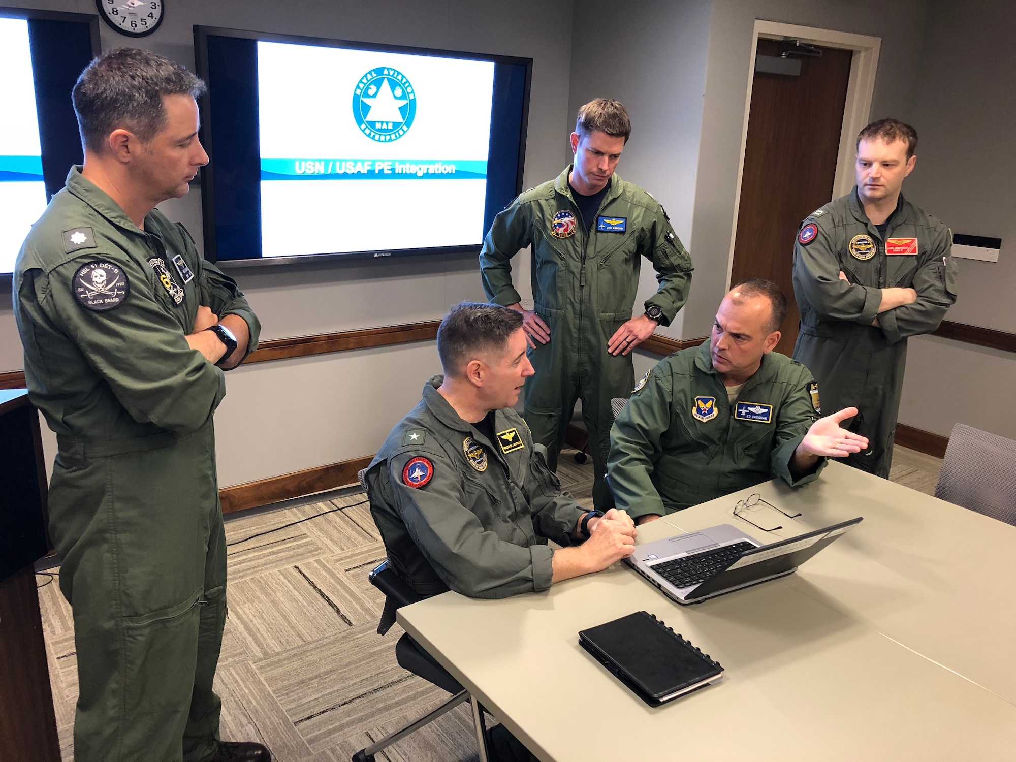 Members of the Navy Physiological Episodes Action Team and Air Force PEAT listen to a discussion between Rear Adm. Fredrick R. “Lucky” Luchtman (left) and Air Force Brig. Gen. Edward L. “Hertz” Vaughan (right) as they lay the ground work for the Joint Physiological Episodes Action Team, or J-PEAT. (U.S. Navy Courtesy Photo by Scot Cregan)