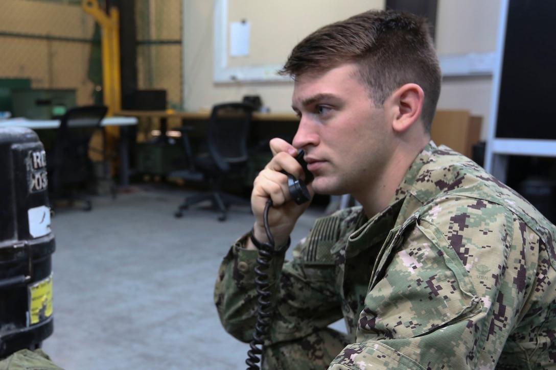 A petty officer talks on the phone.