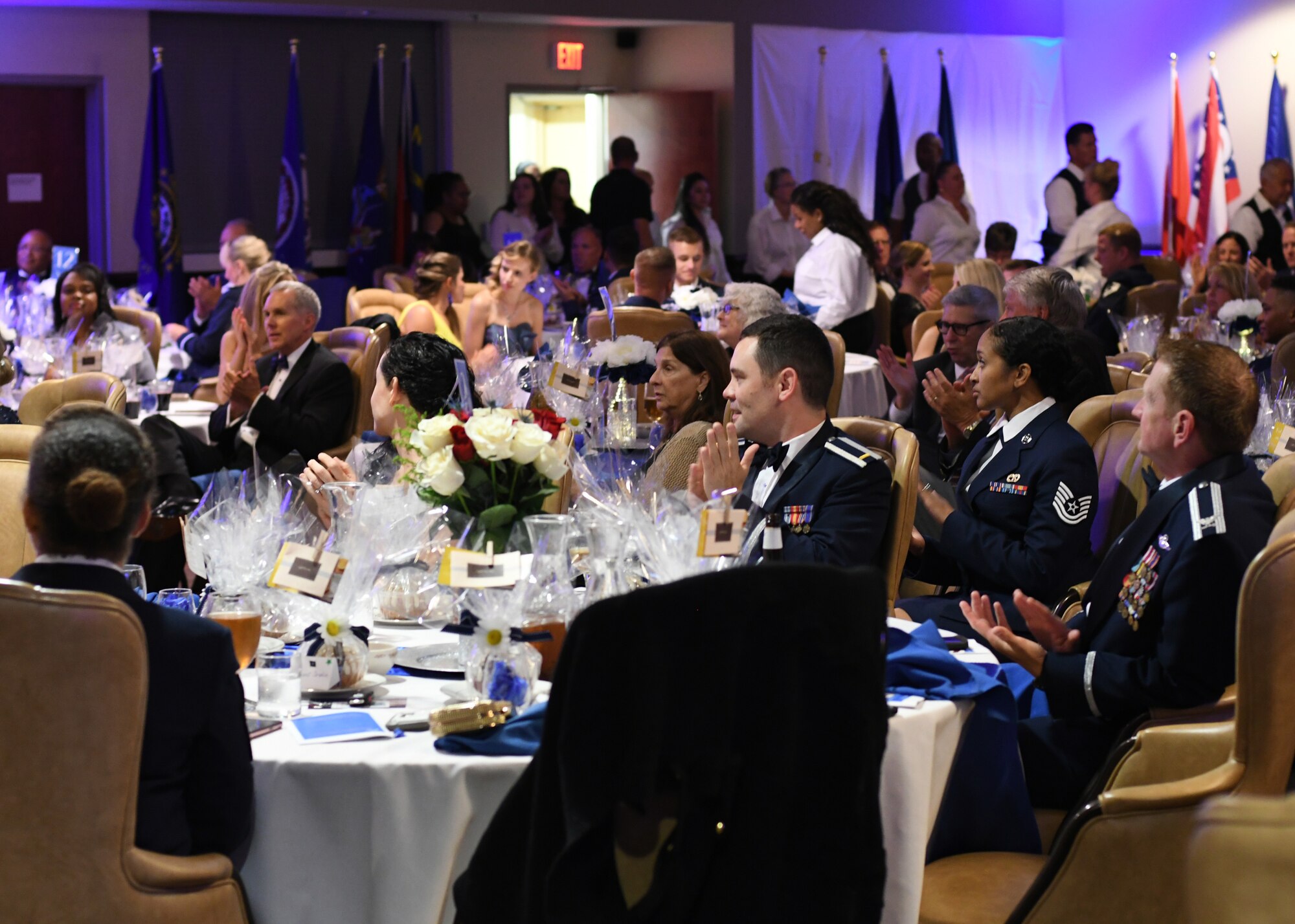 Air Force Ball attendees clap as Col. Wayne Waddell, United States Air Force retired, finishes speaking at Dobbins Air Reserve Base, Ga, Sept. 8, 2018. During the ball, which was hosted by the 94th Airlift Wing, Waddell spoke about his time as a prisoner of war in Vietnam, and answered questions that any attendees may have had with regards to his imprisonment. (U.S. Air Force Photo by Staff Sgt. Miles Wilson)