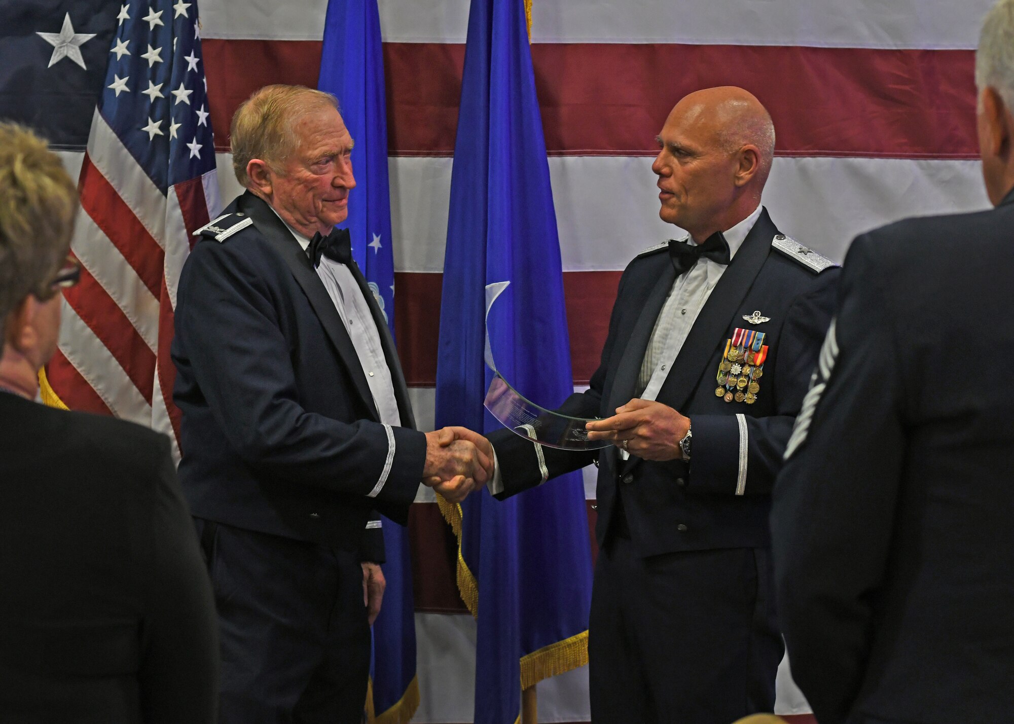 Col. Wayne Waddell, United States Air Force retired, accepts an award of appreciation from Brig. Gen. Richard Kemble, 94th Airlift Wing commander, at Dobbins Air Reserve Base, Ga, Sept. 8, 2018. Waddell was a guest speaker at an Air Force Ball hosted by the 94th AW, and spoke about his time as a prisoner of war in Vietnam. (U.S. Air Force Photo by Staff Sgt. Miles Wilson)