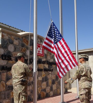 Once the flown flag is lowered it is handled respectfully in preparation to be folded.