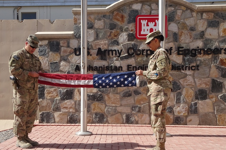 Precisely and uniformly the U. S. flag is being folded by SFC Michael Pineda and Lt. Col. Malia Pearson in preparation for presentation.