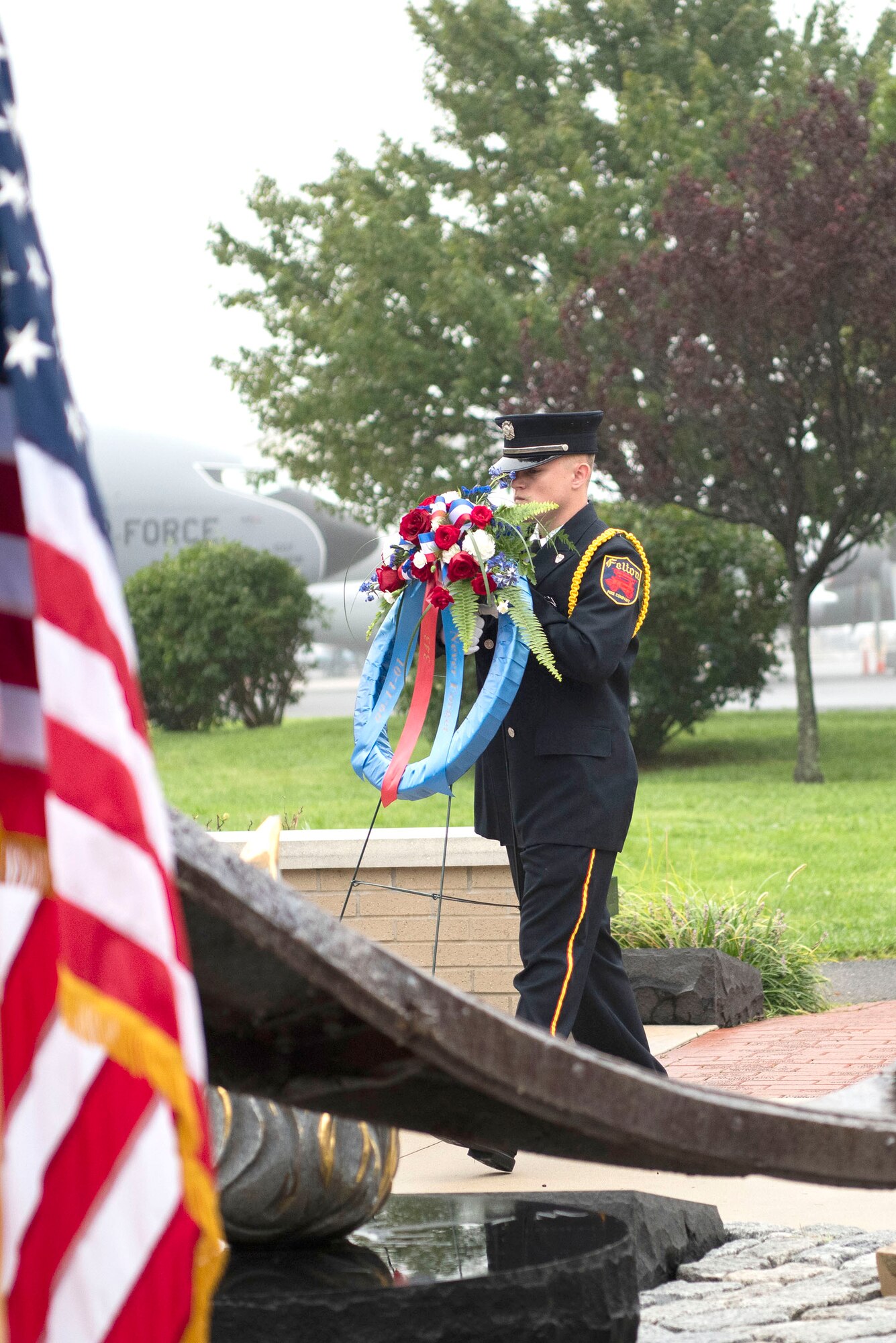 Tyler Moore, a firefighter with the Felton Fire Company, lays a wreath during a 9/11 Memorial Service Sept. 11, 2018, at the Air Mobility Command Museum’s 9/11 Memorial on Dover AFB, Delaware. The museum’s 9/11 Memorial includes two pieces of steel from the World Trade Center, a rock from the United Airlines Flight 93 crash site and a block from the damaged portion of the Pentagon building.