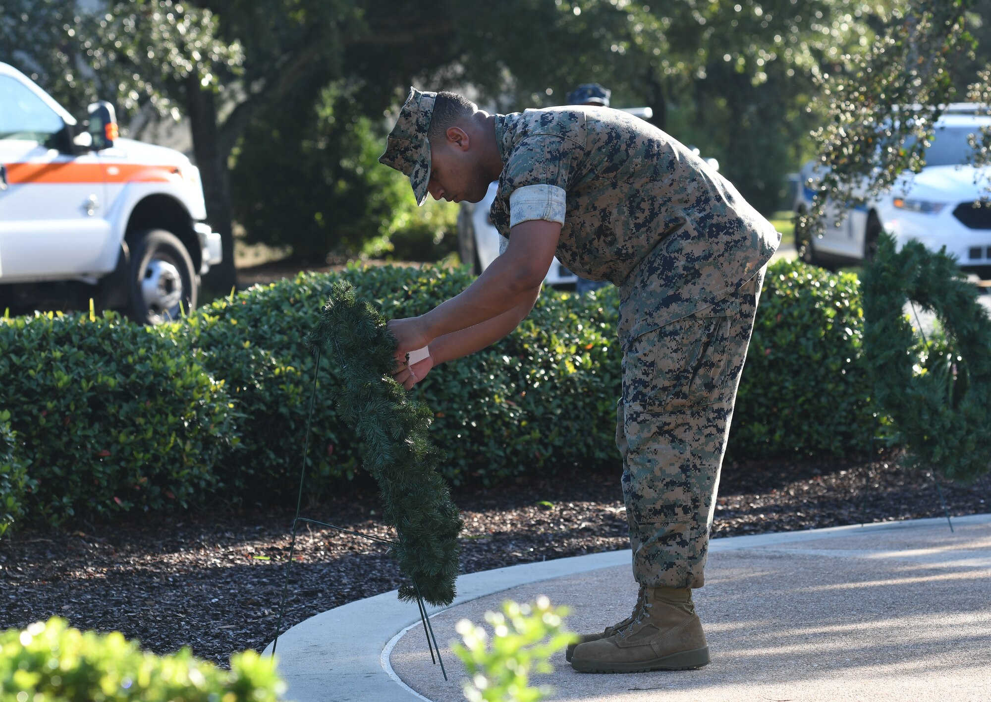 U.S. Marine Corps Private 1st Class Victor Vargas, Keesler Marine Detachment student, places a name tag on a memorial wreath during a 9/11 ceremony in front of the 81st Training Wing headquarters building at Keesler Air Force Base, Mississippi, Sept. 11, 2018. The event honored those who lost their lives during the 9/11 attacks. (U.S. Air Force photo by Kemberly Groue)