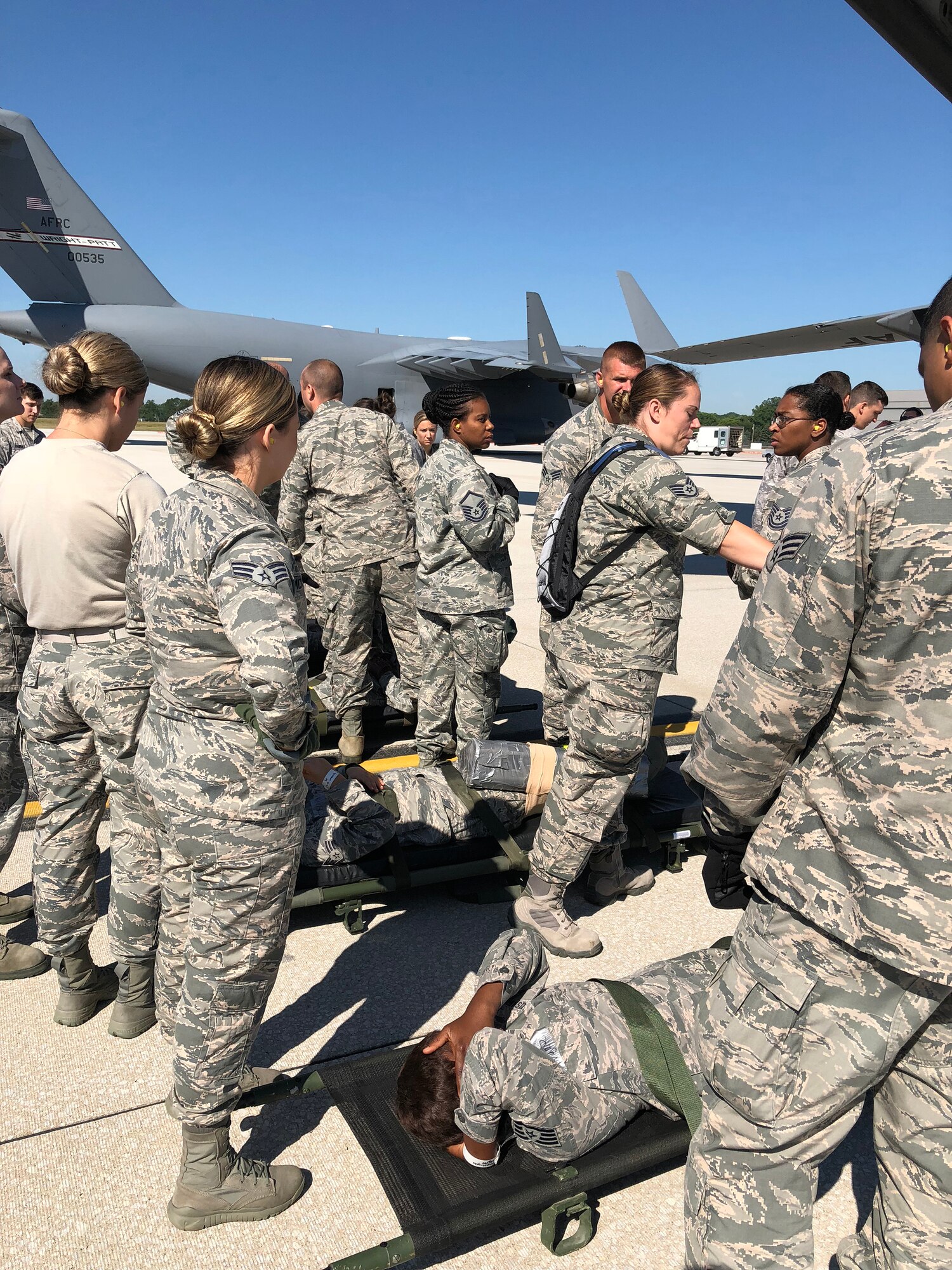 Airmen from the 445th Aeromedical Staging Squadron and 445th Aeromedical Evacuation Squadron work together as they prepare simulated patients played by ASTS Airmen for a flyaway mission July 18, 2018.