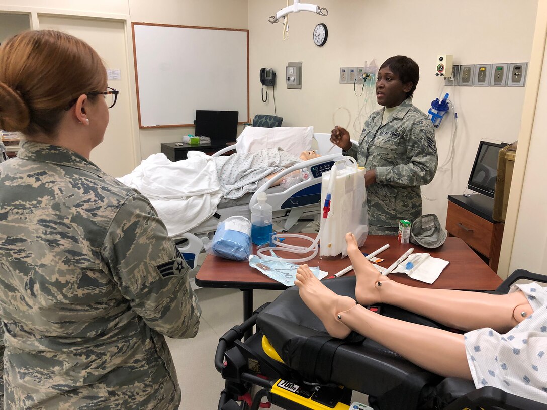 Staff Sgt. Michelle Aholia, 445th Aeromedical Staging Squadron training instructor, gives instructions to her fellow Airmen from ASTS on chest tube insertion and care at the Dayton Veterans Affairs Medical Center’s simulator lab during the squadron’s annual tour July 23, 2018. The Airmen also practiced suture care and participated in an IV station that day.