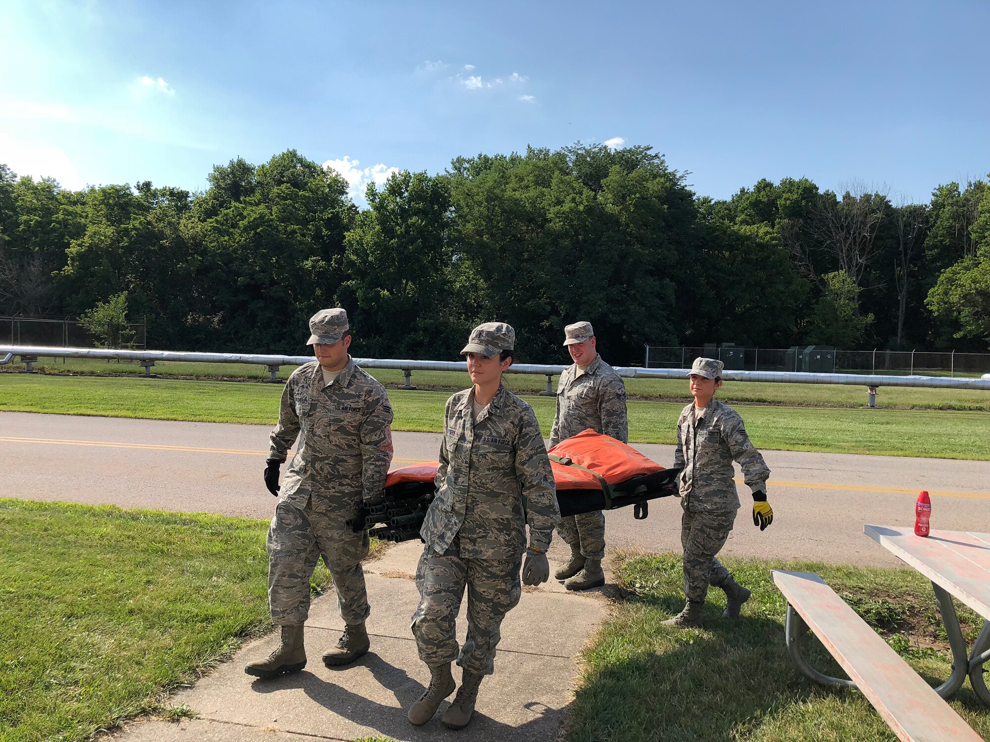 Airmen from the 445th Aeromedical Staging Squadron participate in a four-man litter carry training event as part of their annual tour July 25, 2018. The squadron trained 66 Airmen during their two-week annual tour here July 15-31, 2018.