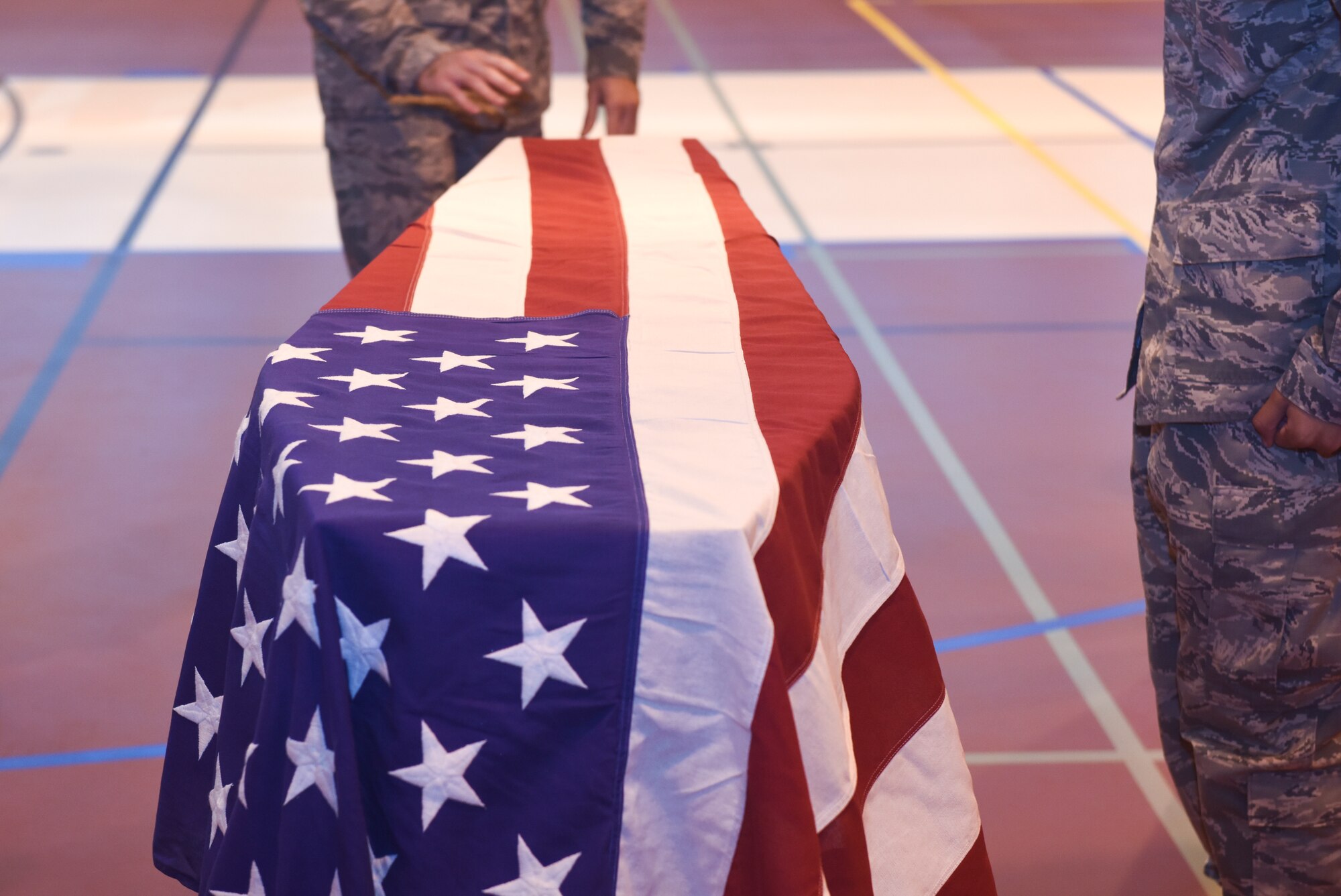 Team Mildenhall Honor Guard conduct the laying of an American flag over a casket during a practice at RAF Mildenhall, England Sept. 5, 2018. Honor guard drapes the flag as an expression of the deceased’s patriotism, love and service to the country. (U.S. Air Force photo by Airman 1st Class Brandon Esau)