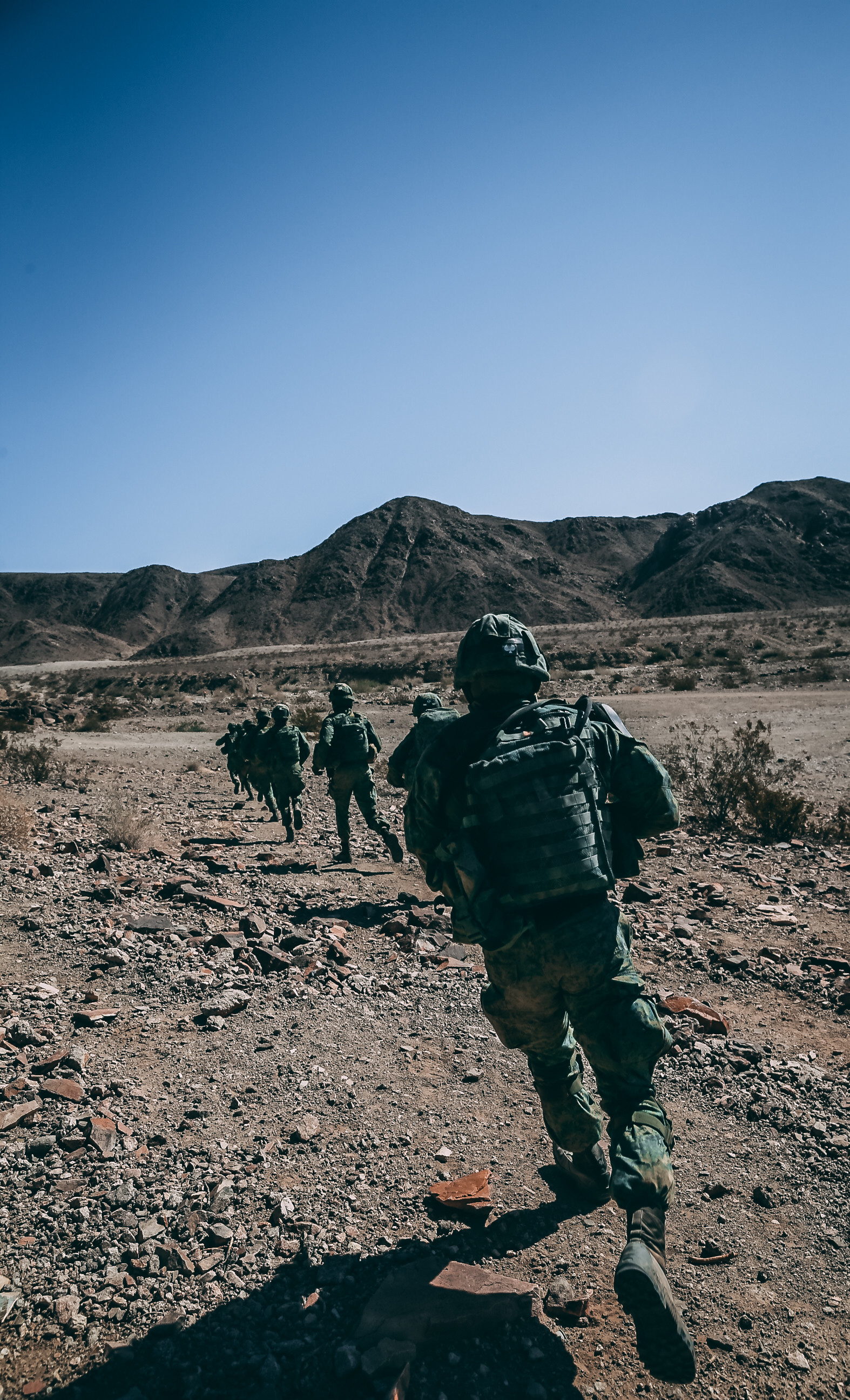 Singapore Guardsmen sprint across a danger area for a ground assault on Range 400 during Valiant Mark 2018 aboard the Marine Corps Air Ground Combat Center, Twentynine Palms, Calif., Sept. 5, 2018. Valiant Mark is an annual exercise conducted by U.S. Marines and the Singapore Armed Forces designed to facilitate increased interoperability and strengthen military-to-military relationships through combined-arms integration skills training. (U.S. Marine Corps photo by Lance Cpl. William Chockey)