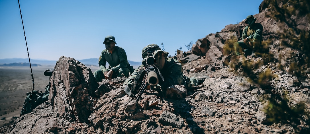 Singapore Guardsmen provides sniper support for a ground assault on Range 400 during Valiant Mark 2018 aboard the Marine Corps Air Ground Combat Center, Twentynine Palms, Calif., Sept. 5, 2018. Valiant Mark is an annual exercise conducted by U.S. Marines and the Singapore Armed Forces designed to facilitate increased interoperability and strengthen military-to-military relationships through combined-arms integration skills training. (U.S. Marine Corps photo by Lance Cpl. William Chockey)