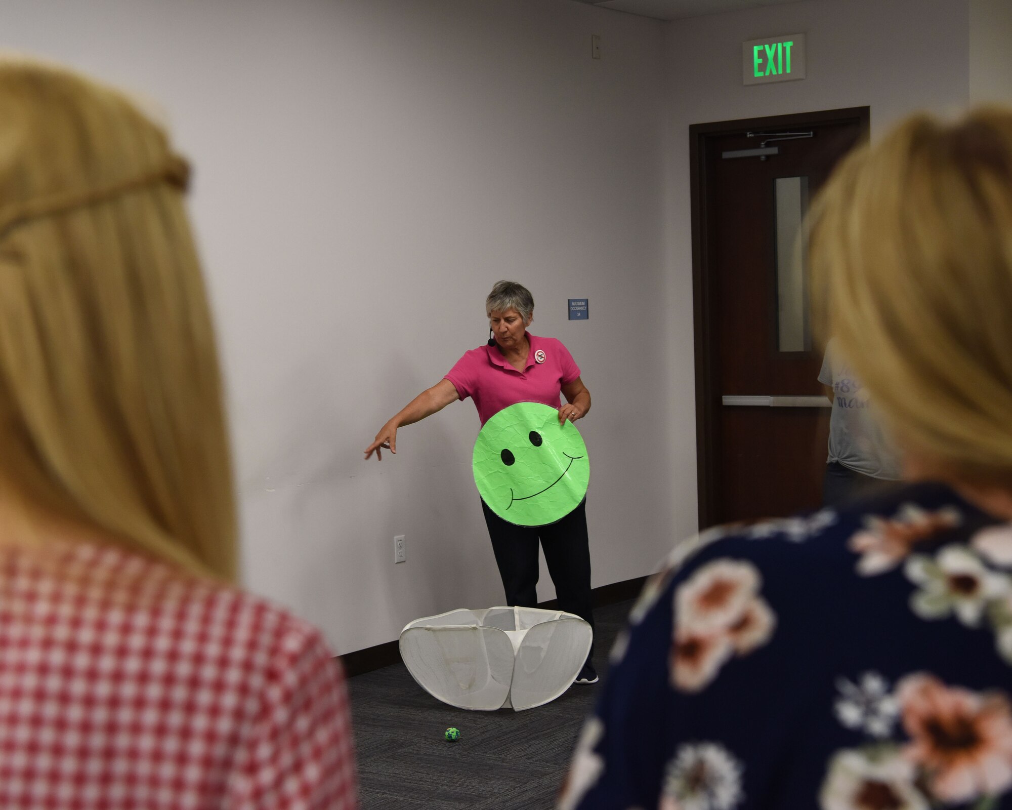 Dr. Diane H. Craft, a physical education professor, demonstrates a clean-up activity during a seminar Sept. 5, 2018 at Luke Air Force Base, Ariz.