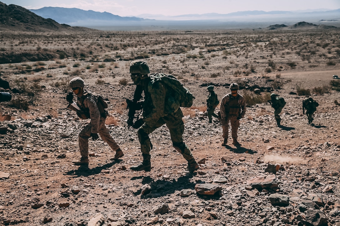 Singapore Guardsmen and U.S. Marines with 2nd Battalion, 7th Marine Regiment begin a ground assault on Range 400 during Valiant Mark 2018 aboard the Marine Corps Air Ground Combat Center, Twentynine Palms, Calif., Sept. 5, 2018. Valiant Mark is an annual exercise conducted by U.S. Marines and the Singapore Armed Forces designed to facilitate increased interoperability and strengthen military-to-military relationships through combined-arms integration skills training. (U.S. Marine Corps photo by Lance Cpl. William Chockey)