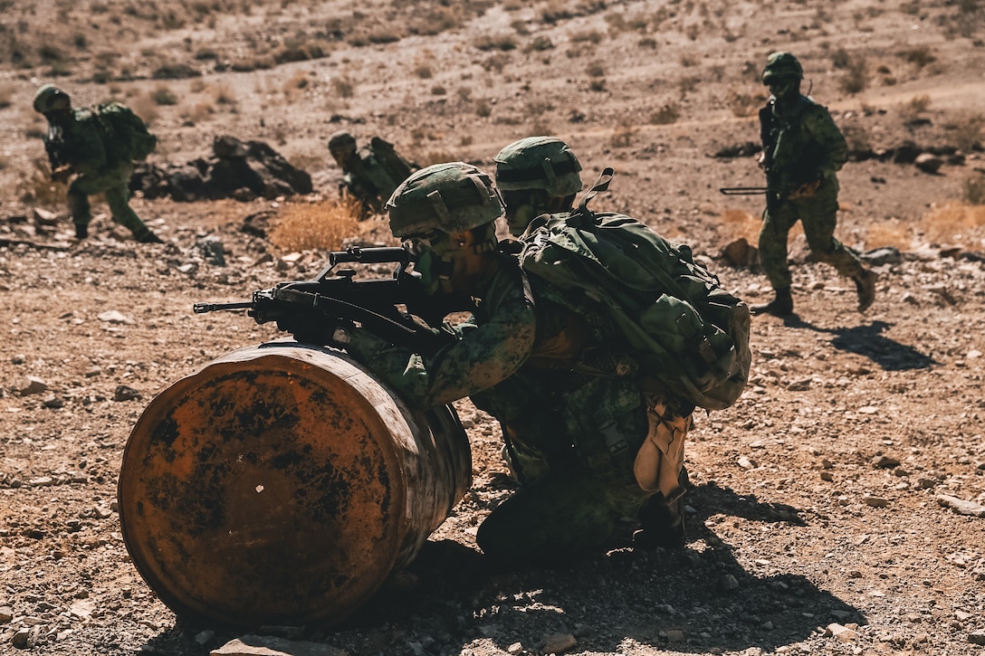 Singapore Guardsmen provide security for a ground assault on Range 400 during Valiant Mark 2018 aboard the Marine Corps Air Ground Combat Center, Twentynine Palms, Calif., Sept. 5, 2018. Valiant Mark is an annual exercise conducted by U.S. Marines and the Singapore Armed Forces designed to facilitate increased interoperability and strengthen military-to-military relationships through combined-arms integration skills training. (U.S. Marine Corps photo by Lance Cpl. William Chockey)