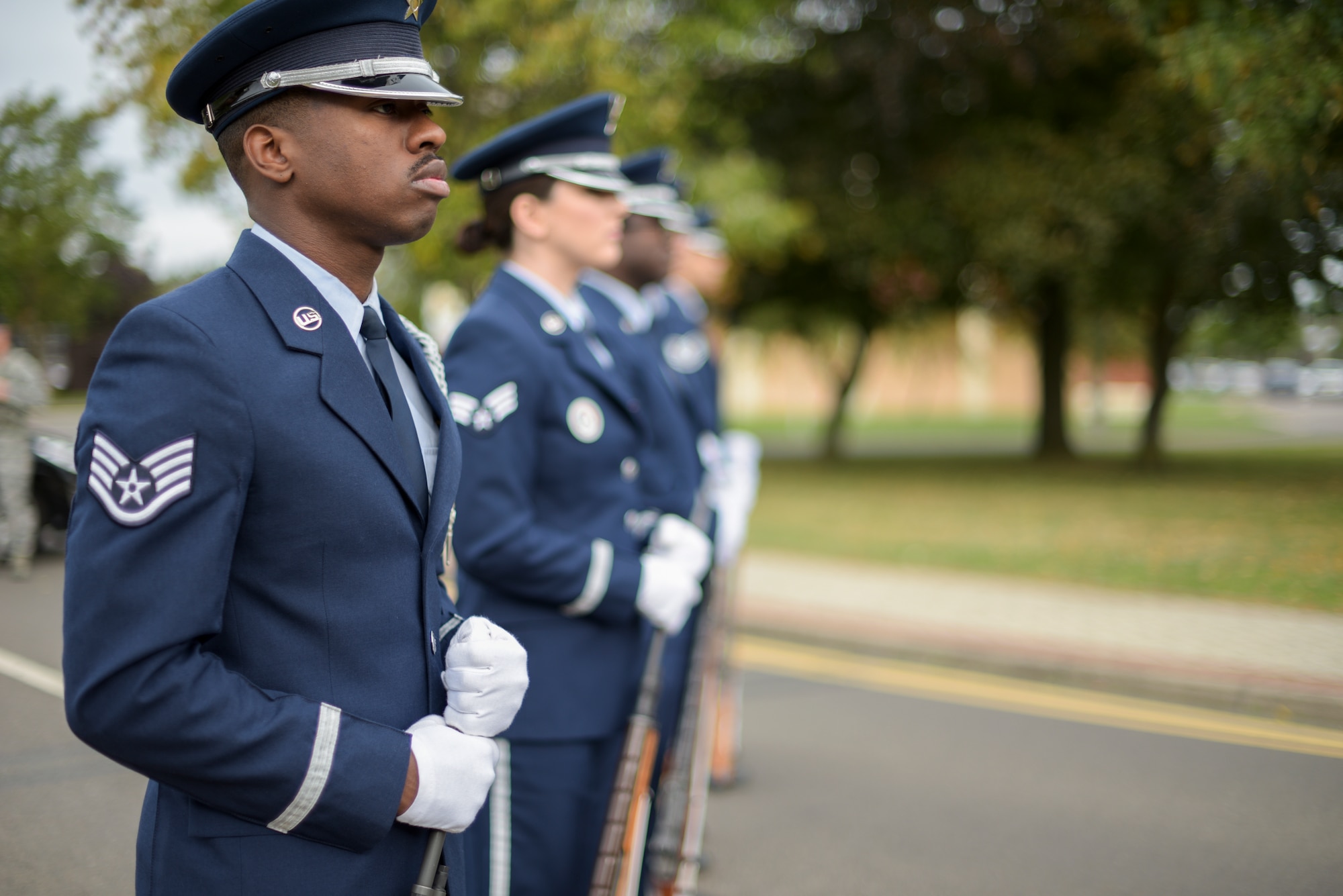 Members of the Team Mildenhall Honor Guard stand by during a 9/11 ceremony at RAF Mildenhall Sep. 11, 2018.  While progressing in their respective career fields, the RAF Mildenhall Honor Guard members also commit about 16 hours of training and up to 30 hours of details a month. (U.S. Air Force photo by Tech. Sgt. Emerson Nuñez)