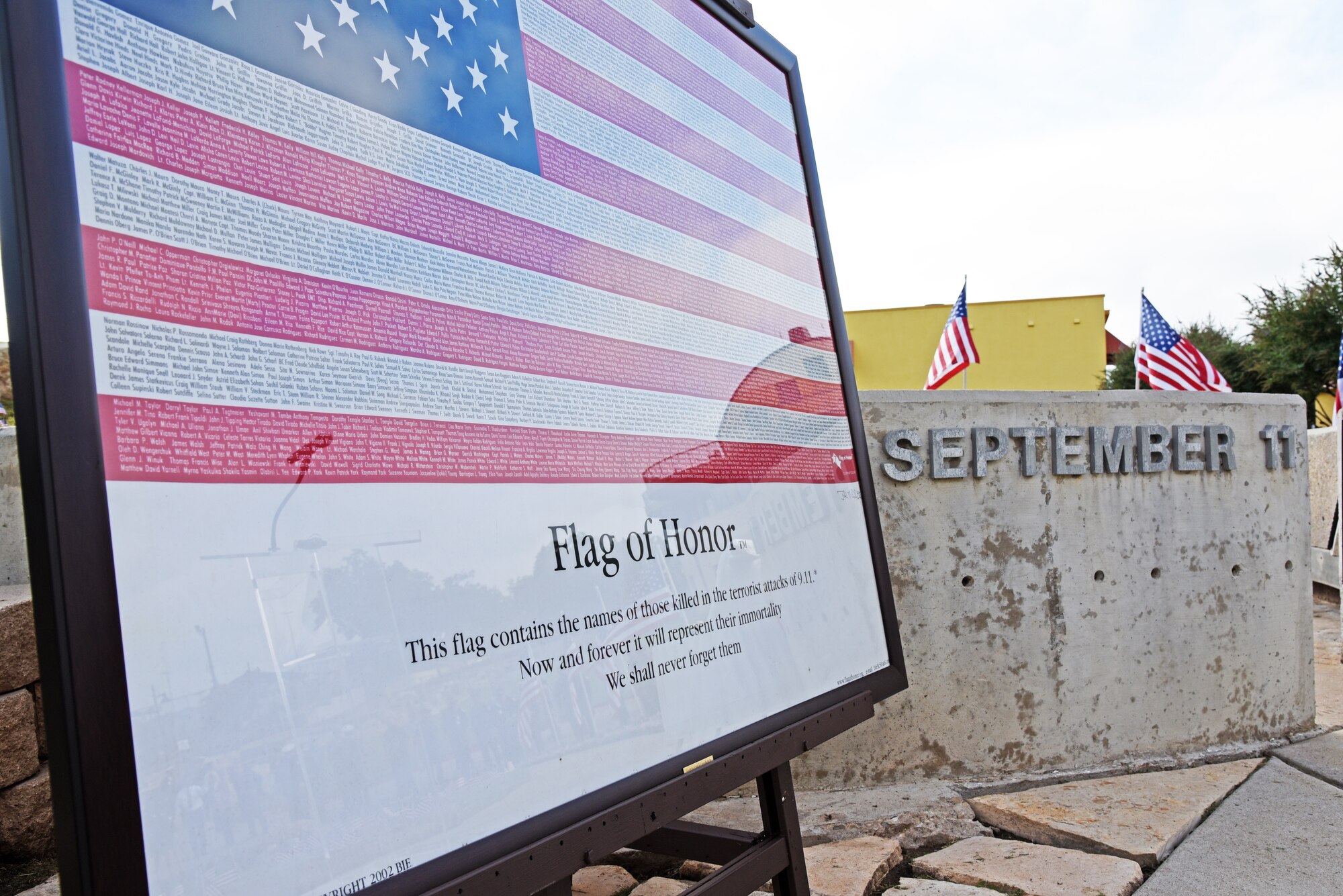 A flag containing the names of all the victims of the Sept. 11, 2001, terrorist attacks rests on an easel at the 9/11 memorial near the San Angelo Museum of Fine Arts in San Angelo, Texas, Sept. 11, 2018. San Angelo hosted a 9/11 ceremony to honor the 2,977 victims who died during the attacks. (U.S. Air Force photo by Staff Sgt. Joshua Edwards/Released)