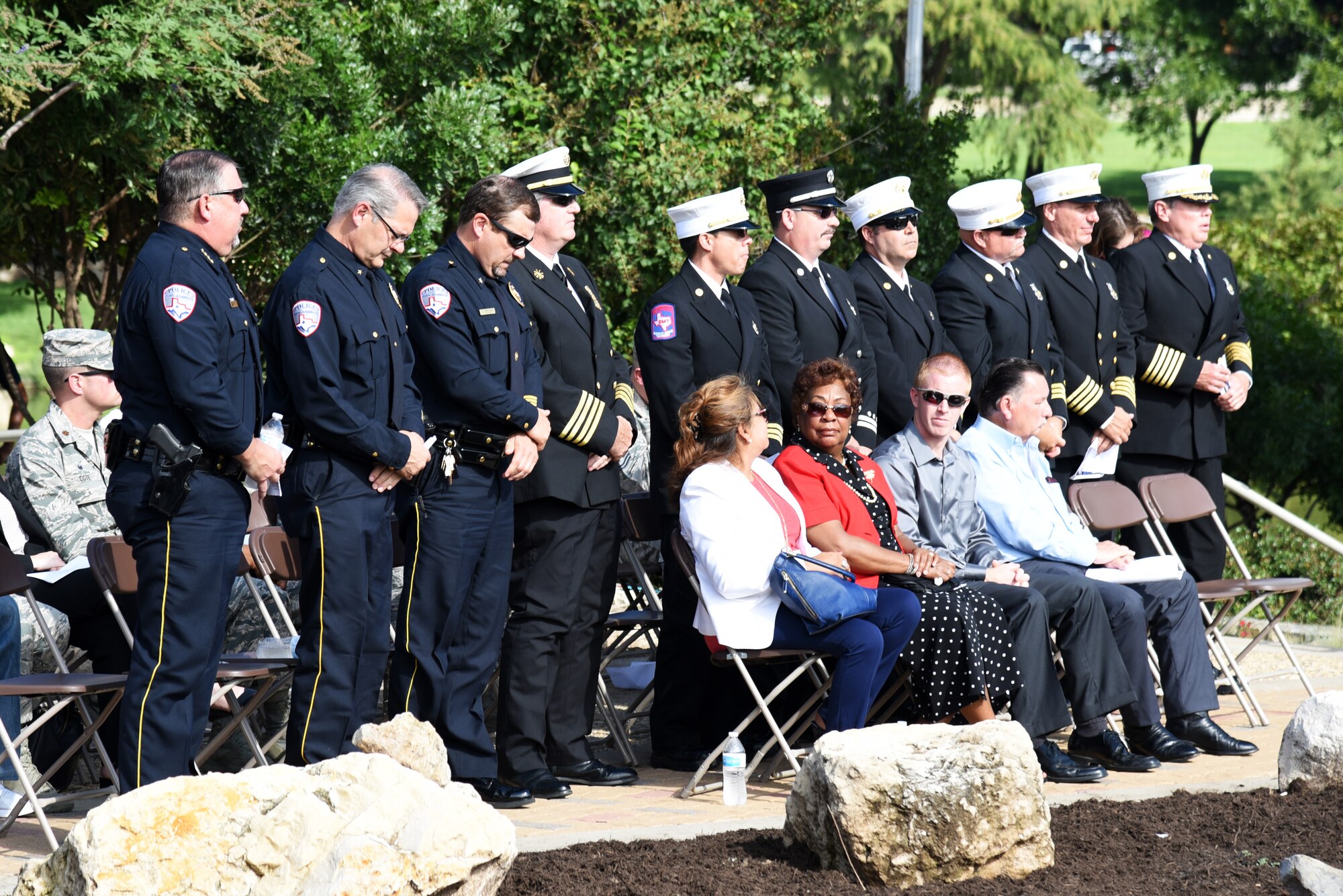 Police officers and firefighters stand to be recognized during the 9/11 remembrance ceremony at the 9/11 memorial near the San Angelo Museum of Fine Arts in San Angelo, Texas, Sept. 11, 2018. U.S. Air Force Col. Ricky Mills, 17th Training Wing commander, asked them to stand to be recognized because, like 403 first responders that died on Sept. 11, 2001, they are willing to put their lives on the line for others. (U.S. Air Force photo by Staff Sgt. Joshua Edwards/Released)