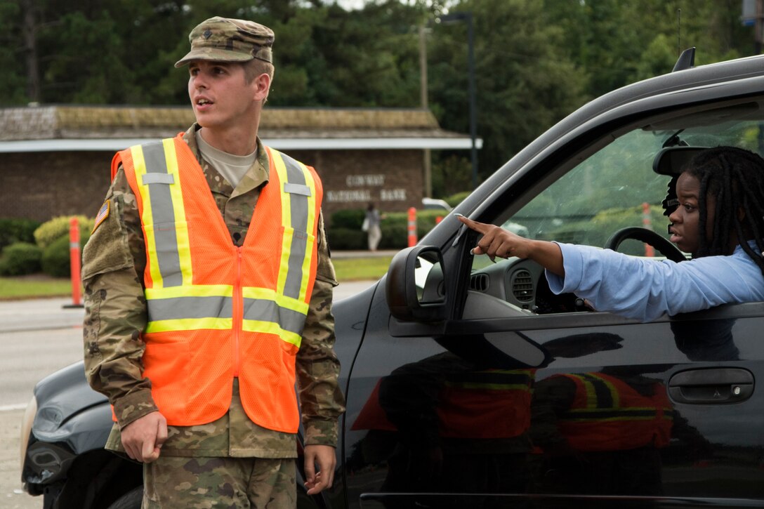 A National Guard soldier speaks with a motorist.