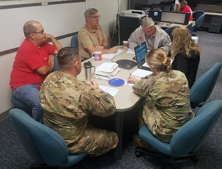 Members of the Emergency Management Team and the district Emergency Operations Center huddle in preparation of today's deployment of 13 temporary power team members to North Carolina ahead of Hurricane Florence's anticipated landfall.