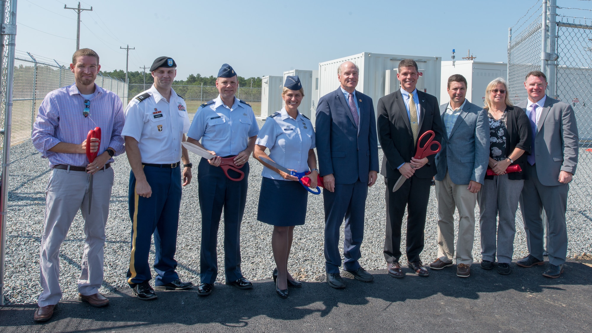 Leaders of the Otis Microgrid project pose for a photo following the ribbon cutting ceremony.