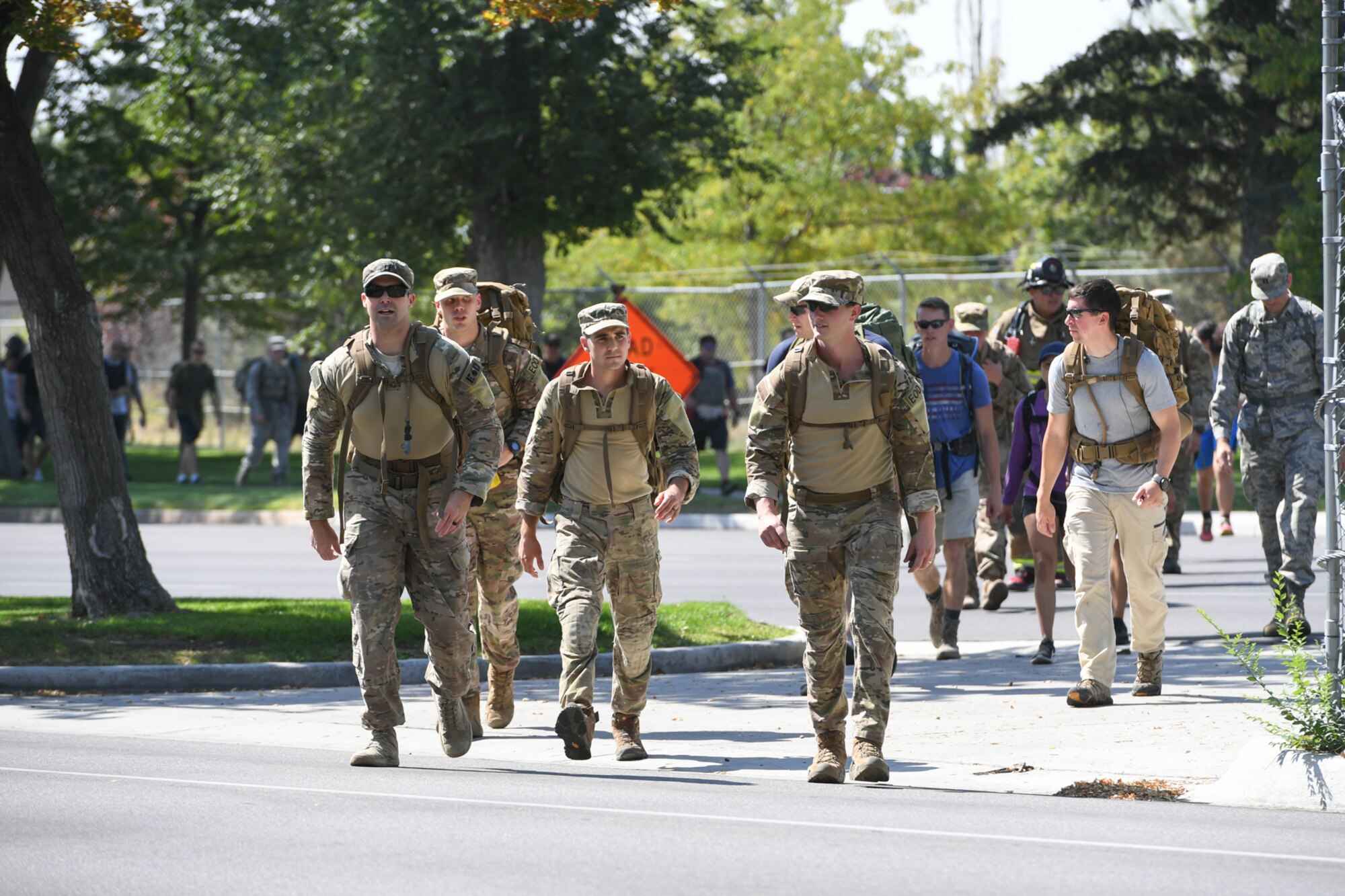 Members from Hill Air Force Base's 775th Civil Engineering Squadron alongside Kaysville and Layton fire and police Departments, walk together during the 9/11 Memorial Ruck March, commemorating the Sept. 11 terrorist attacks. This is Hill's 3rd annual ruck march and the first teaming up with first responders from local communities. The march started in Kaysville and ended at Hill Air Force Base South Gate, a total of 9.11 miles.
