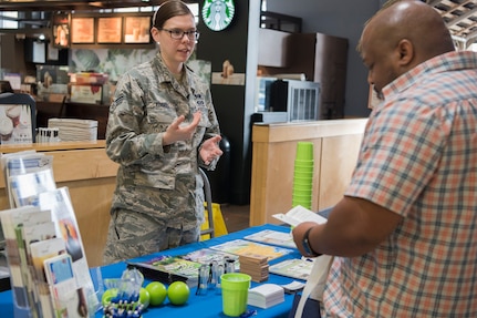 Senior Airman Amber Edgell, a 773d Civil Engineer Squadron emergency management journeyman, speaks to Frank Belton, a 773d CES unit program coordinator, about emergency kits and being prepared during National Preparedness Month at Joint Base Elmendorf-Richardson, Alaska, Sept. 7, 2018. Emergency kits are essential to preparedness. They should be tailored to a geographical region and contain the basic essentials to survive for three days.