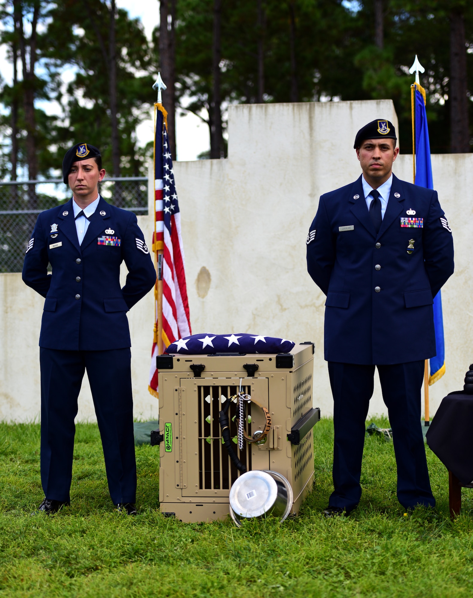 U.S. Air Force Staff Sgt. Caitlin Bourque, left, and Staff Sgt. Marcus Lavalais, right, 325th Security Forces Squadron military working dog (MWD) handlers, stand alongside the effects of MWD Jack during Jack’s memorial service at Tyndall Air Force Base, Fla., Sept. 7, 2018. Jack was an explosives and patrol dog who shared a special bond with his handlers. MWDs enhance security forces capabilities to protect resources, enforce military laws, suppress drugs, detect explosives and protect installations. (U.S. Air Force photo by Senior Airman Isaiah J. Soliz)