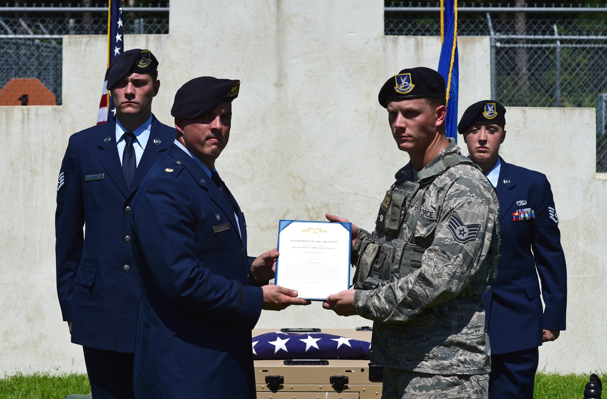 U.S. Air Force Maj. Joshua Frizzell, 325th Security Forces Squadron commander, left, presents a decoration to Staff Sgt. Quinton Pigg, prior 325th Security Forces Squadron military working dog (MWD) handler, right, on behalf of MWD Jack during Jack’s memorial service at Tyndall Air Force Base, Fla., Sept. 7, 2018. Jack, a Belgian Malinois, was an explosives and patrol dog who shared a special bond with his handlers. Pigg and Jack were paired together during their time at Tyndall. (U.S. Air Force photo by Senior Airman Isaiah J. Soliz)