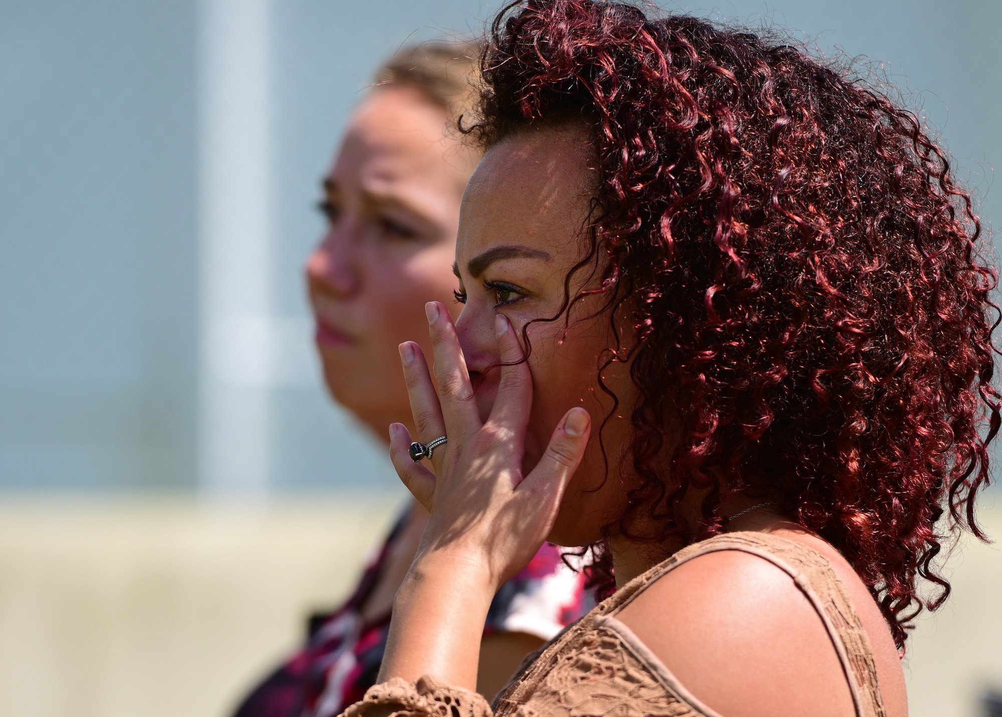 An attendee wipes away tears during a military working dog (MWD) memorial service at Tyndall Air Force Base, Fla., Sept. 7, 2018. MWD Jack was an explosives and patrol dog who shared a special bond with his handlers. MWDs enhance Security Forces capabilities to protect resources, enforce military laws, suppress drugs, detect explosives and protect installations. (U.S. Air Force photo by Senior Airman Isaiah J. Soliz)