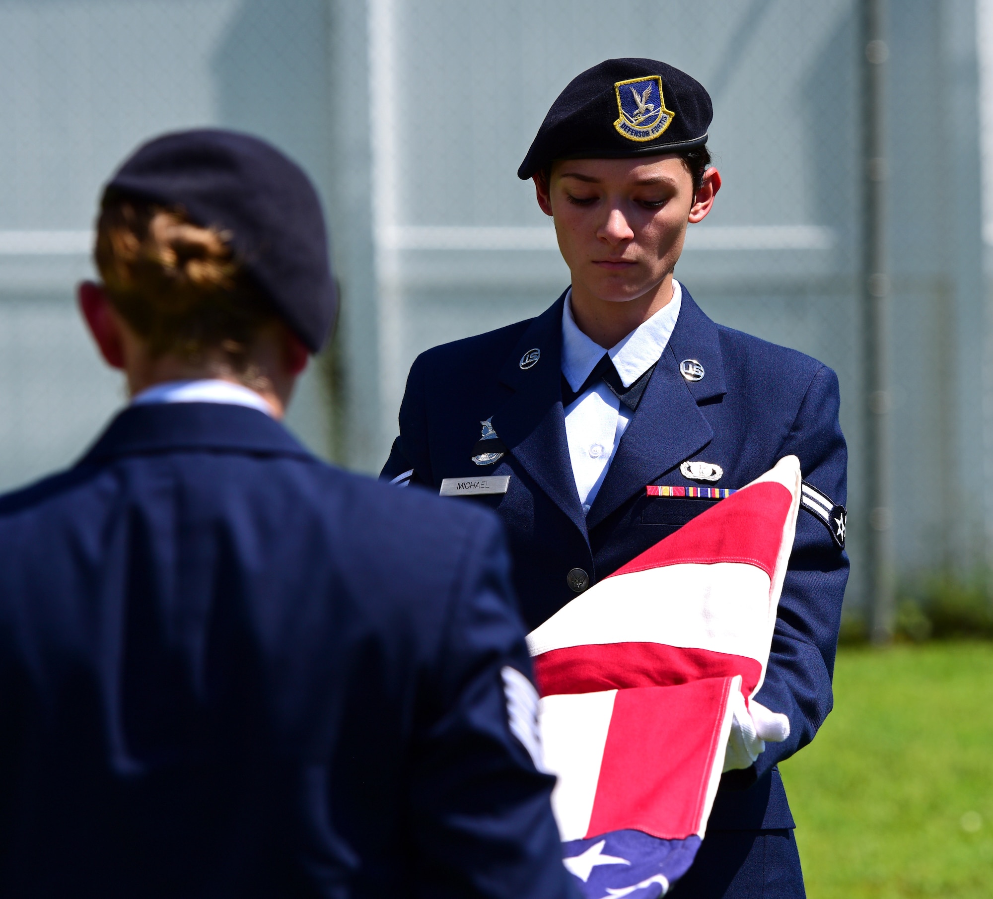 U.S. Air Force Airman 1st Class Arleen Michael, right, and Staff Sgt. Katelyn Grau, left, 325th Security Forces Squadron Airmen, ceremoniously fold the U.S. Flag in remembrance of military working dog (MWD) Jack during his memorial service at Tyndall air Force Base, Fla., Sept. 7, 2018. Jack, a Belgian Malinois, was an explosives and patrol dog who shared a special bond with his handlers. MWDs are afforded military customs and courtesies. (U.S. Air Force photo by Senior Airman Isaiah J. Soliz)