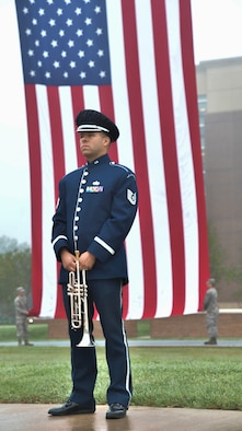 Tech. Sgt. Michael P. Ramos, U.S. Air Force Ceremonial Brass Band trumpeter, stands in reverence during the invocation at the 9/11 Memorial Service on Joint Base Andrews, Md., Sept. 11, 2018. Ramos played “To the Colors” at the beginning of the ceremony and ended the event with “Taps.”