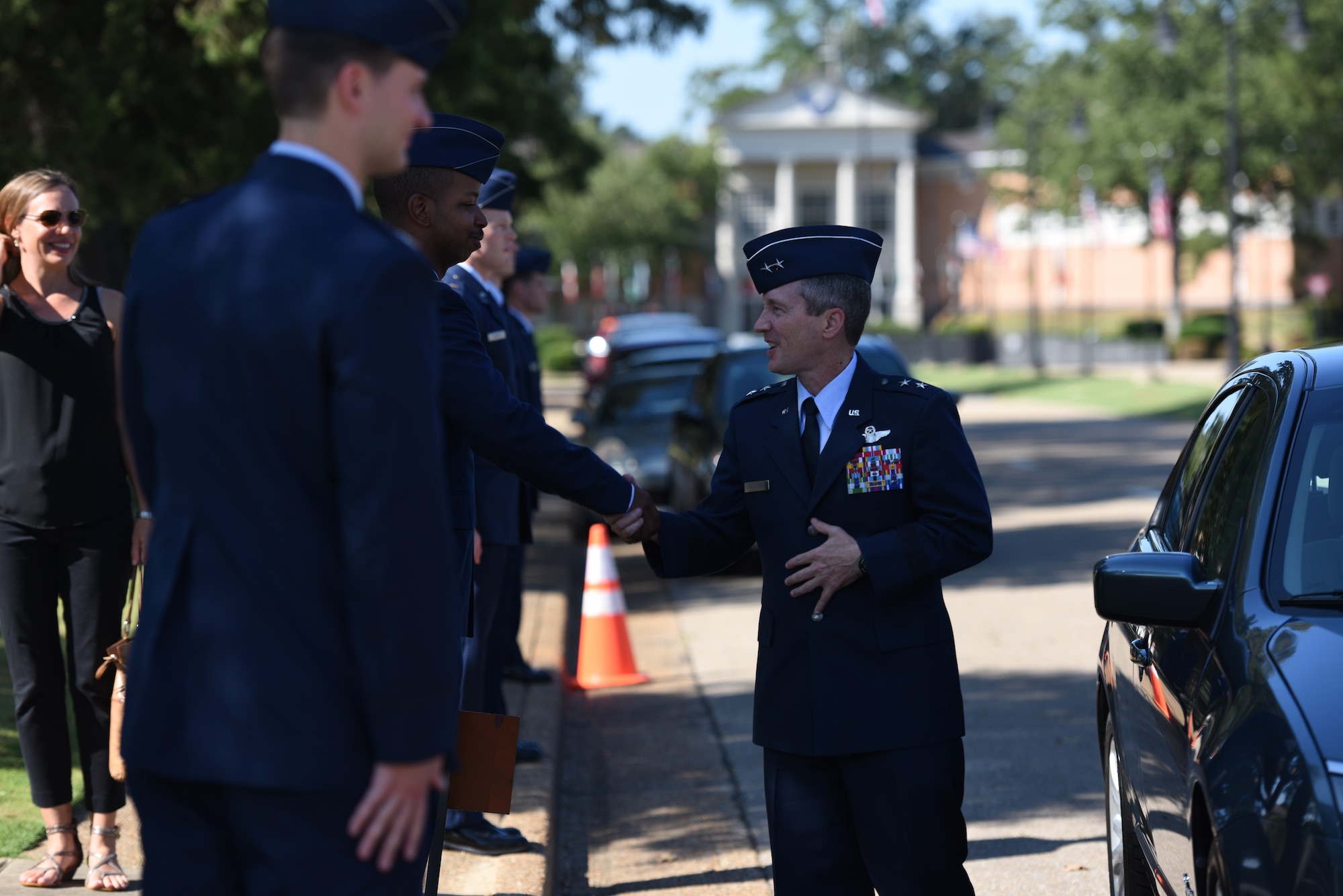 Maj. Gen. Michael D. Rothstein, commander of the Curtis E. LeMay Center and vice commander of Air University at Maxwell Air Force Base, Alabama, greets students of Specialized Undergraduate Pilot Training Classes 18-14/15 at their graduation Sept. 7, 2018, on Columbus Air Force Base, Mississippi. Twenty-five officers completed 53 weeks of training in order to become new, highly trained pilots. (U.S. Air Force photo by Airman 1st Class Beaux Hebert)