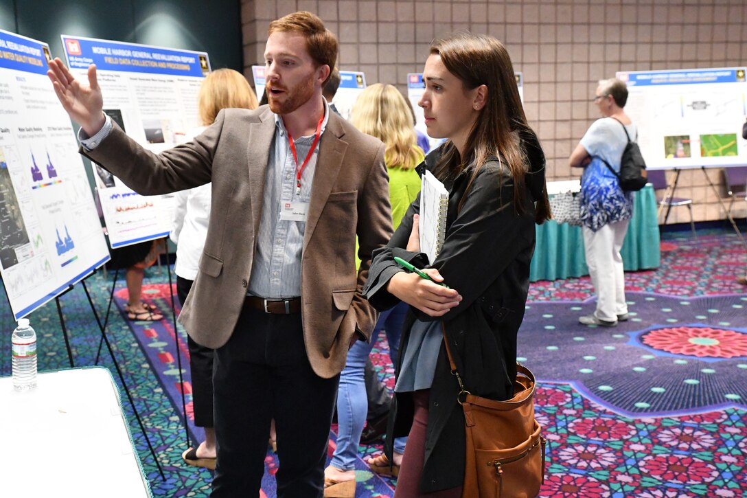 John Bass, Levee Safety Program Manager with the U.S. Army Corps of Engineers Mobile District, speaks with a community member at the Open House hosted by the Corps September 11, 2018 at the Mobile Convention Center in Mobile, Ala. The open house was to explain and to receive public comment on the Mobile Harbor Draft General Reevaluation Report with Supplemental Environmental Impact Statement (Draft GRR/SEIS).