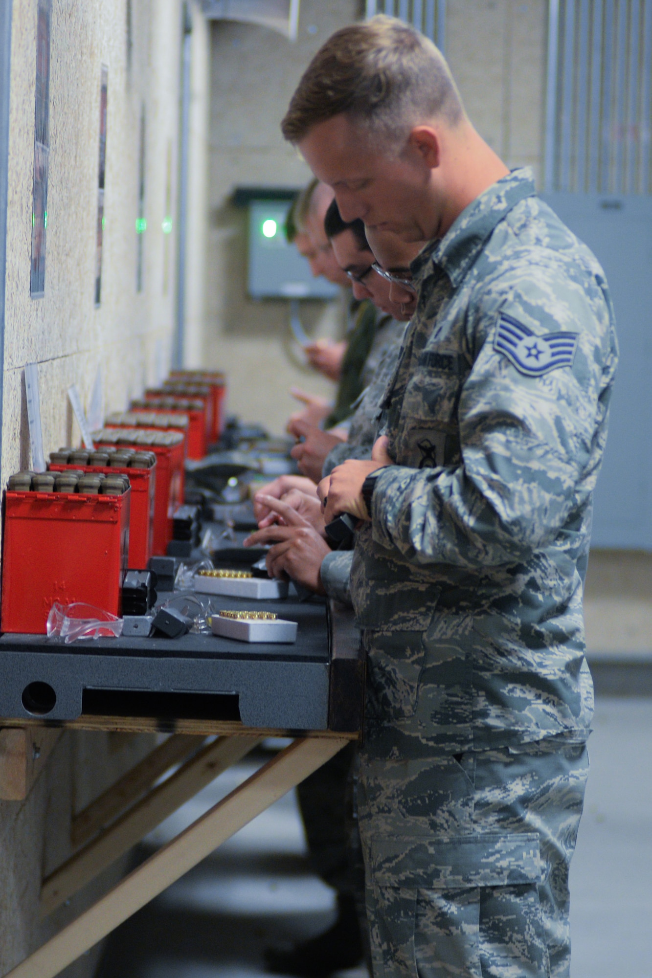 Participants in an Excellence in Competition (EIC) pistol contest prepare their weapons for the event Aug. 30, 2018, at Offutt Air Force Base, Nebraska. This is the second EIC event the 55th Security Forces Squadron has had since completing the renovations of their Combat Arms shooting range earlier this year. The first focused on the use of rifles. (U.S. Air Force photo by Kendra Williams)