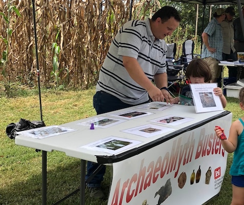 Jordan McIntyre, archaeologist with the U.S. Army Corps of Engineers Nashville District, explains how to protect cultural resources at the ArchaeoMyth Busters table for Tennessee Archaeology Day at Bells Bend Park in Nashville, Tenn., Sept. 8, 2018. (Courtesy Asset)