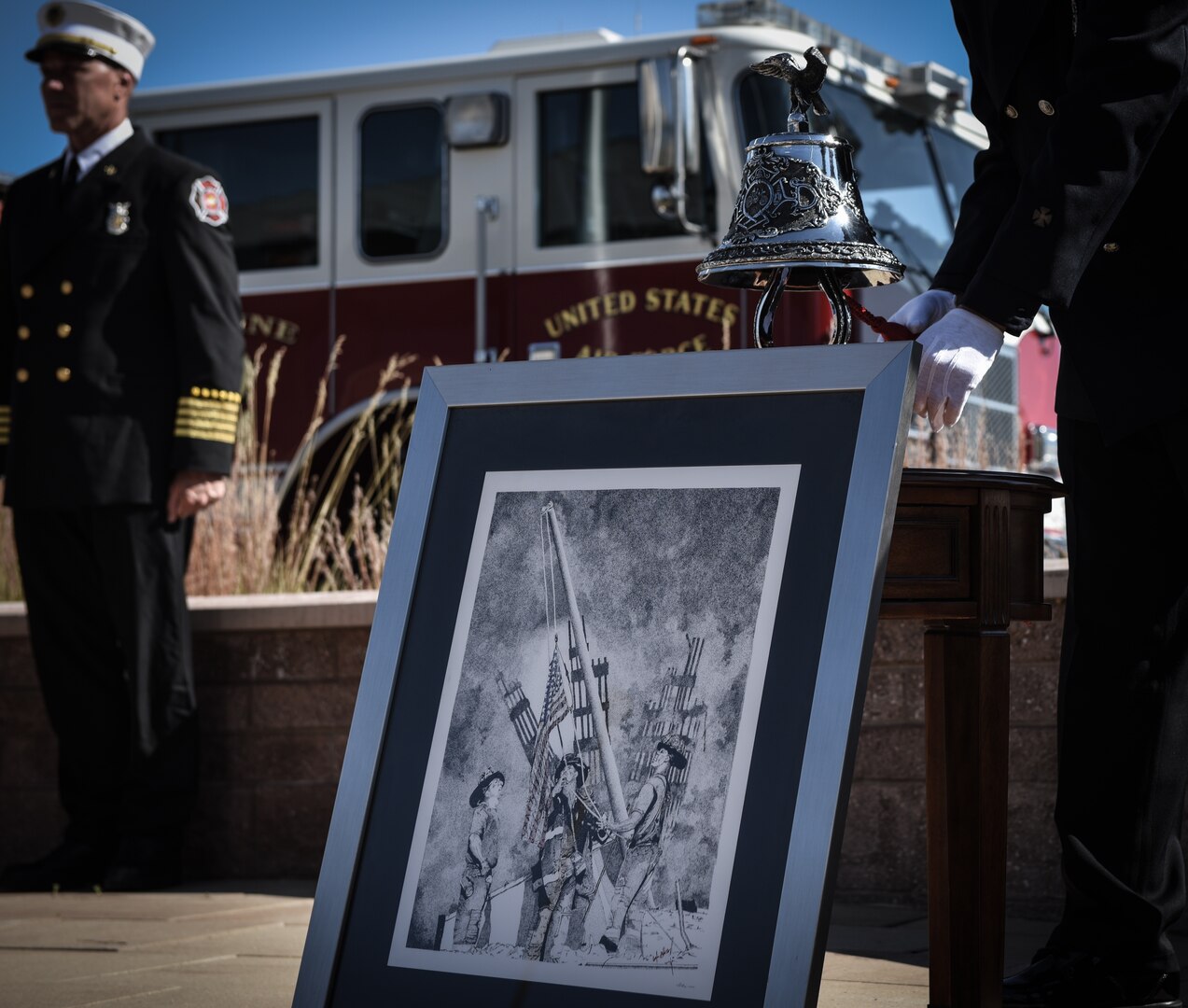 Firefighters assigned to the 460th Civil Engineer Squadron pay their respect to those who sacrificed their lives following the terrorist attacks of 9/11 during a Patriot Day ceremony Sept. 11 2018, on Buckley Air Force Base, Colorado. Team Buckley members held a ceremony in remembrance of the victims and families of those lost in New York, Pennsylvania and the Pentagon during the terrorist attacks on Sept. 11, 2018. (U.S. Air Force photo by Airman 1st Class Michael D. Mathews)