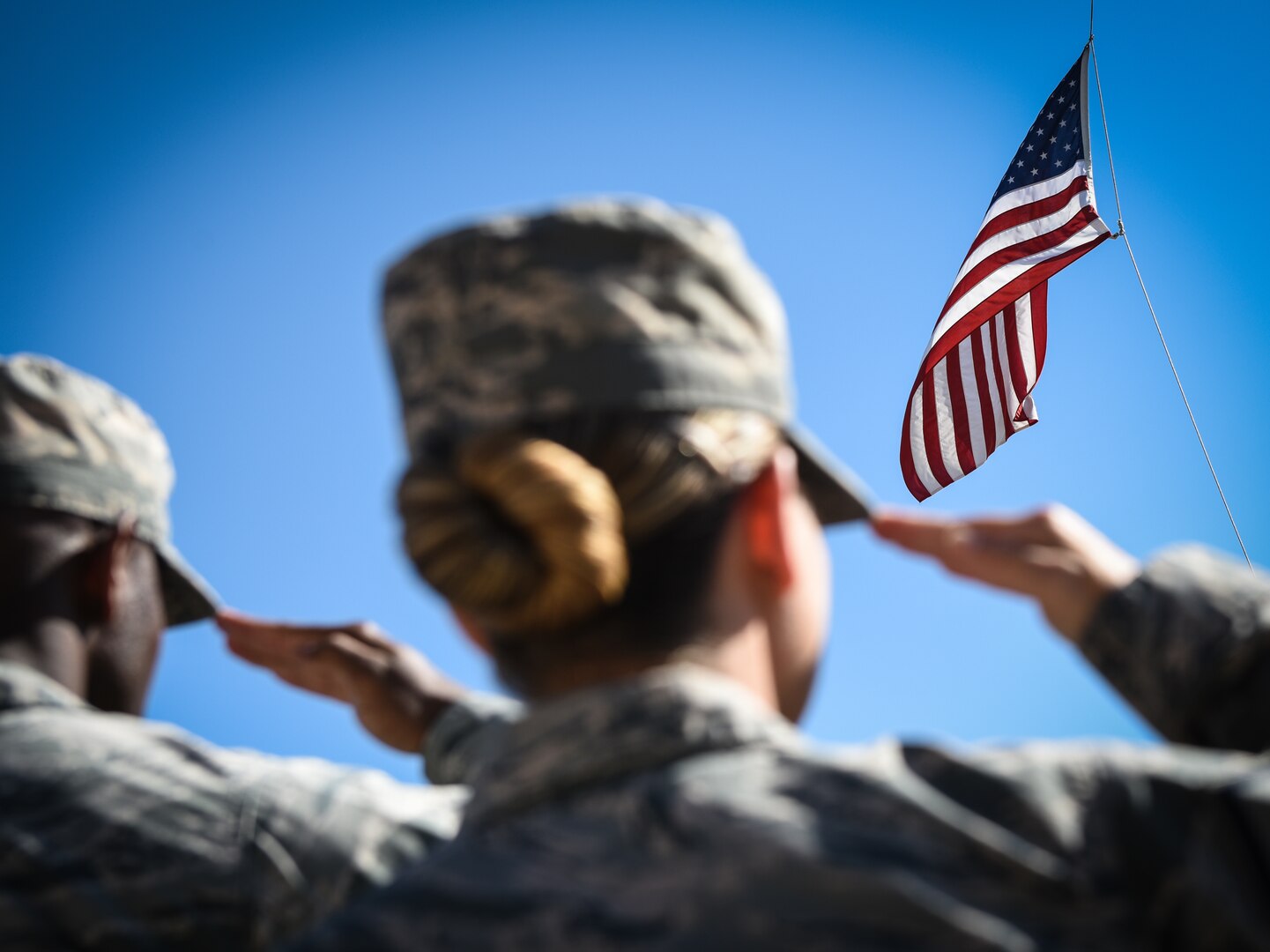 Buckley Air Force Base Airmen salute the United States flag during a Patriot Day ceremony Sept. 11, 2018, on Buckley AFB, Colorado. Team Buckley members held a ceremony in remembrance of the victims and families of those lost in New York, Pennsylvania and the Pentagon during the terrorist attacks on Sept. 11, 2001. (U.S. Air Force photo by Airman 1st Class Michael D. Mathews)