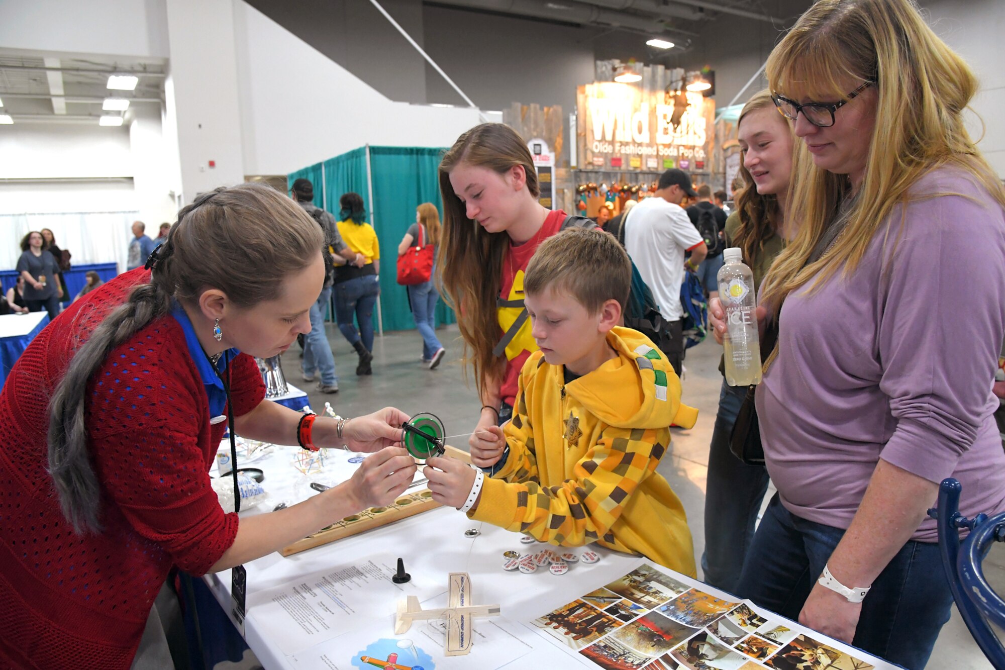 FanX visitors try out toys designed to demonstrate scientific principles and talk with Rachael Beal, 309 Software Maintenance Wing, volunteer at the HAFB STEM Outreach booth, Sept. 7, Salt Lake City.