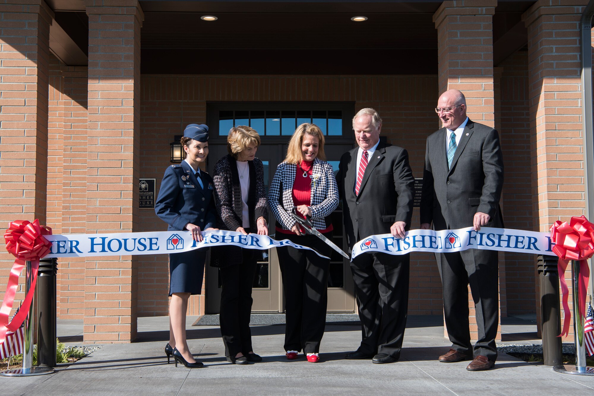 From the left, U.S. Air Force Col. Patricia Csànk, 673d Air Base Wing and Joint Base Elmendorf-Richardson commander; U.S. Senator Lisa Murkowski; Jenny Hall, Fisher House manager; Terry Parks, Friends of Fisher House president, and David Coker, Fisher House Foundation president, participate in a ribbon-cutting ceremony for Fisher House II at JBER, Alaska, Sep. 10, 2018. Fisher House II features a two-story building with more than 14,000 square feet – 16 suites which include a private bedroom and bath, a shared family room, living room, and common kitchen, and laundry facilities for families.