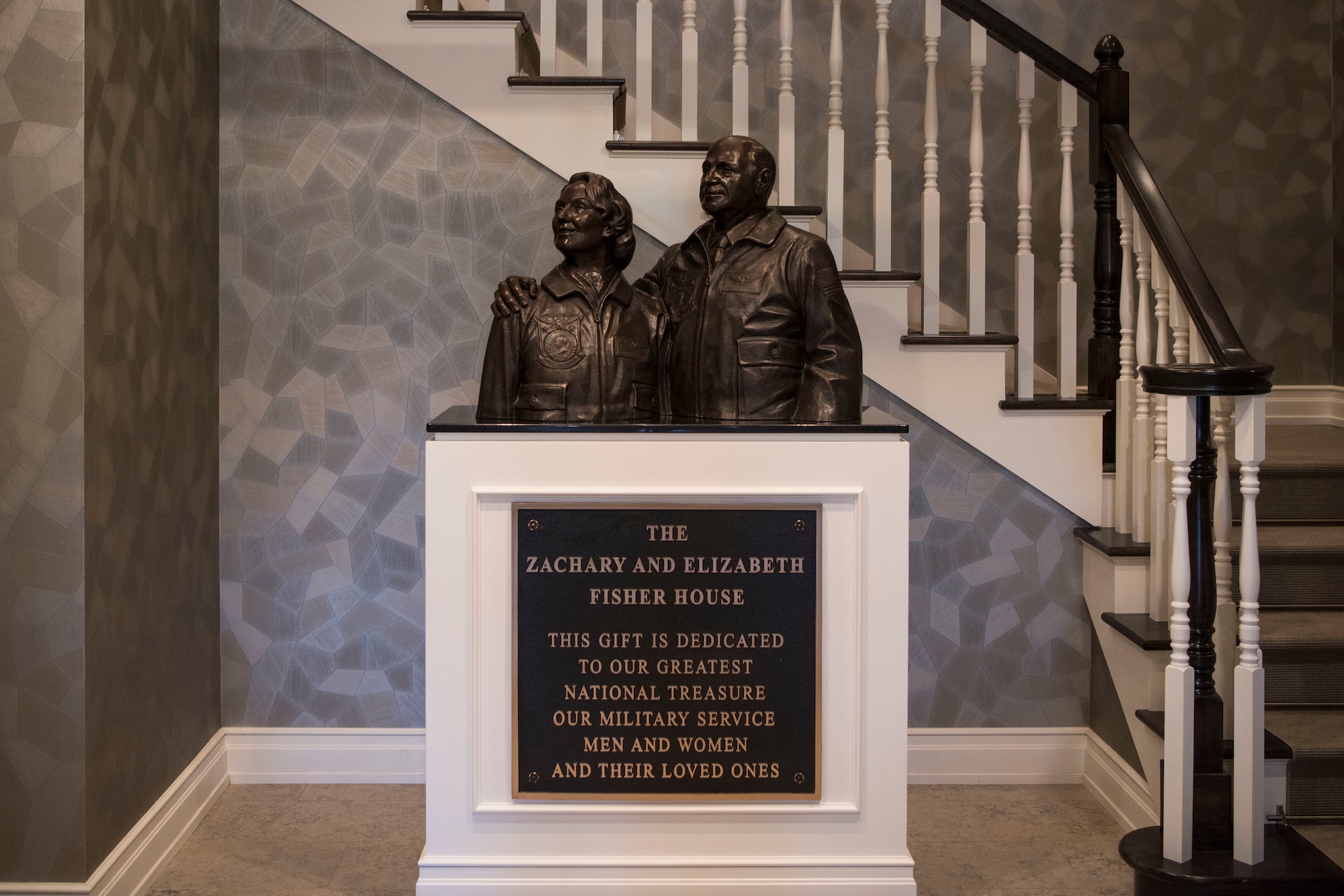 A statue of Zachary and Elizabeth Fisher stands in the foyer of the newly built Fisher House II at Joint Base Elmendorf-Richardson, Alaska, Sep. 10, 2018. The Fisher House Foundation was started in 1990 by the Fishers. The program is a unique private-public partnership established to improve the quality of life for military members, retirees, veterans and their families.