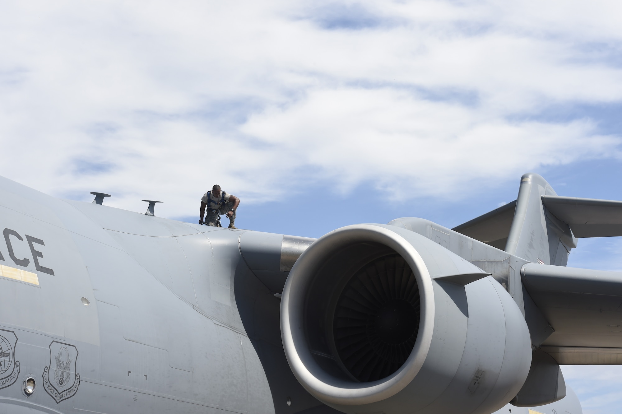 Airman 1st Class Quran Bullock, a 437th Aircraft Maintenance Squadron crew chief, performs post-flight inspections on top of a C-17 Globemaster III Sept. 12, 2018, at Scott Air Force Base, Ill.