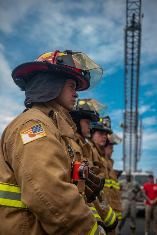 Firefighters from the 18th Civil Engineer Squadron stand at ease before the Kadena Fire Emergency Services 9/11 Memorial Stair Climb Sept. 11, 2018, at Kadena Air Base, Japan. The event was held to honor the sacrifices 417 first responders made during the Sept. 11, 2001, terrorist attacks at the World Trade Center in N.Y. (U.S. Air Force photo by Staff Sgt. Micaiah Anthony)