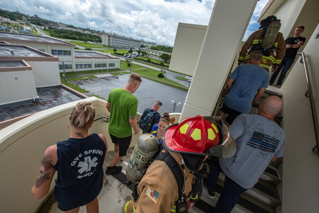 Participants of the Kadena Fire Emergency Services 9/11 Memorial Stair Climb walk up and down a flight of stairs Sept. 11, 2018, at Kadena Air Base, Japan. The event was open to all personnel with base access to honor the sacrifice first responders made during the Sept. 11, 2001, terrorist attacks and remember the victims of that day. (U.S. Air Force photo by Staff Sgt. Micaiah Anthony)